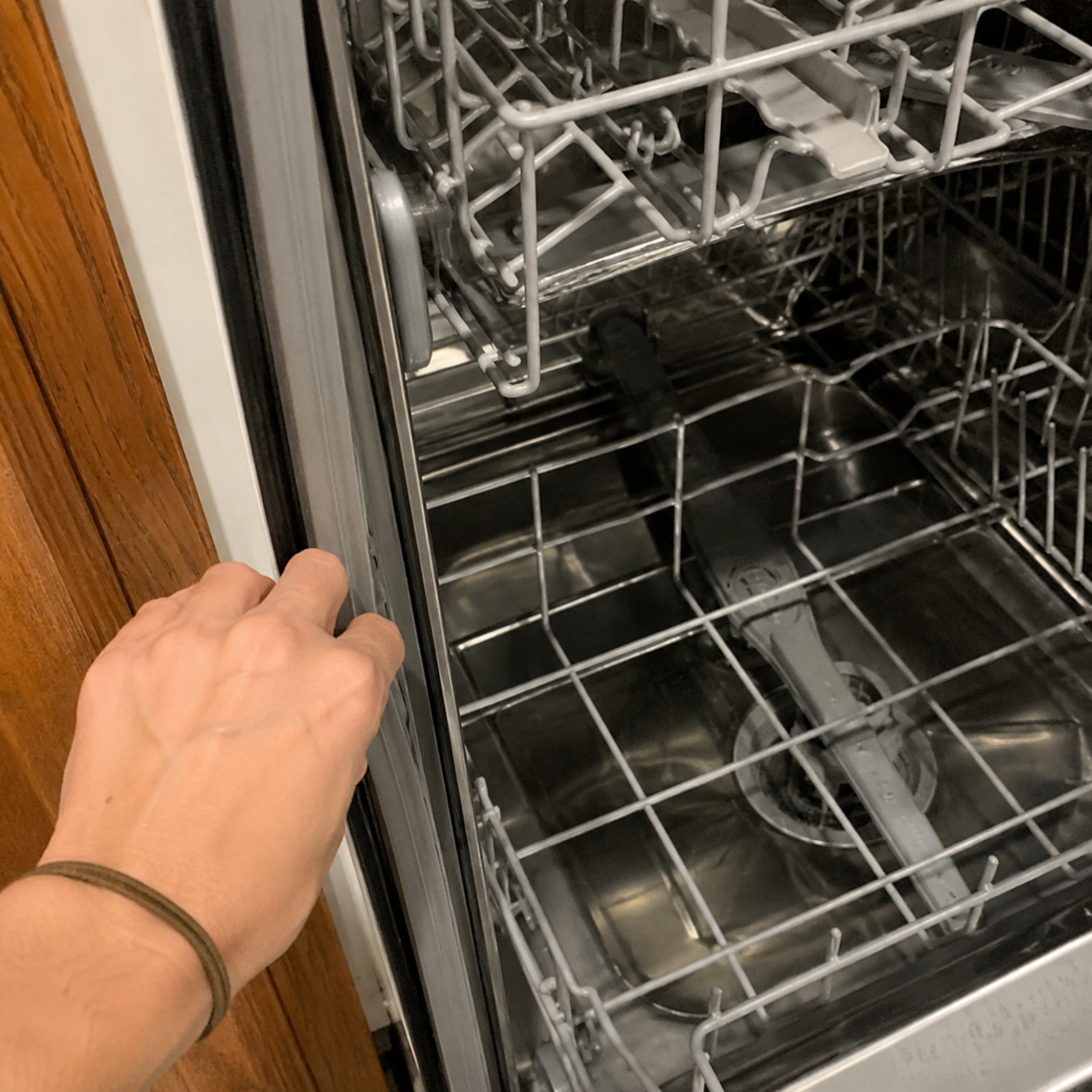 Customer opening and inspecting a dishwasher