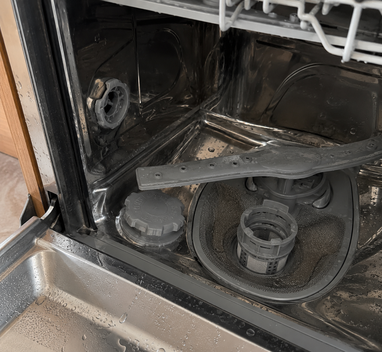 Dishwasher interior showing hidden residue and buildup