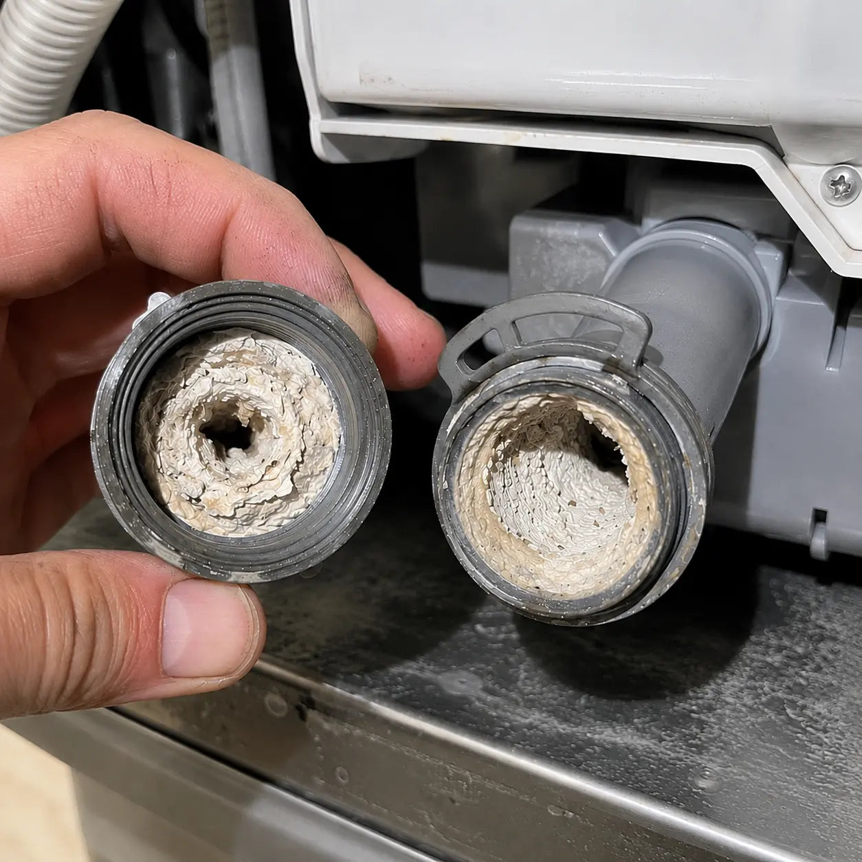 Hard water scale narrowing dishwasher spray arm openings